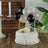 Birthday cake with balloons and flowers on a wooden table.