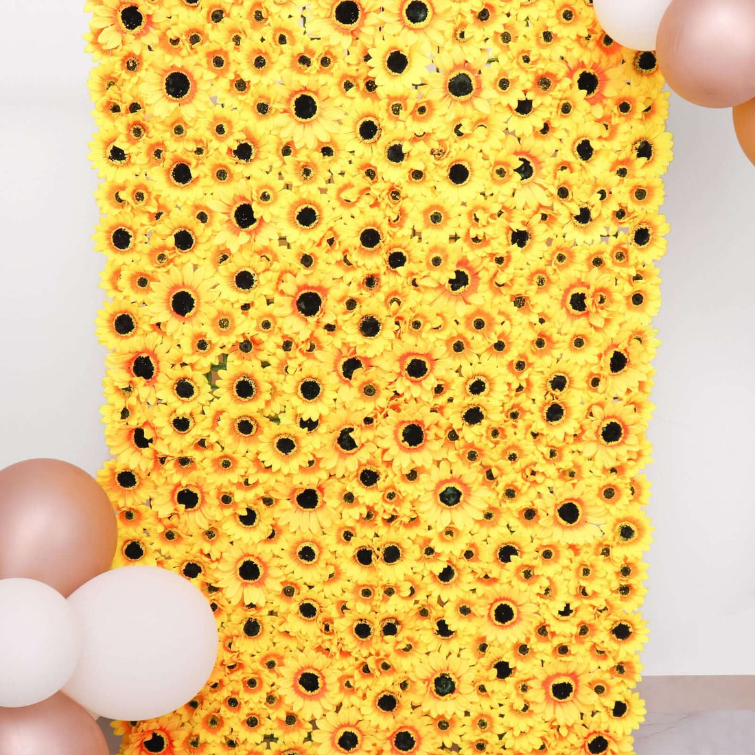 Vibrant sunflower backdrop with decorative balloons for events and photoshoots.