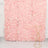 Gold geometric plant stand against a pink floral backdrop.
