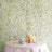 Elegant floral backdrop with champagne glasses and roses on a table.