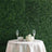 Elegant table setting with champagne flutes and white roses against a green backdrop.