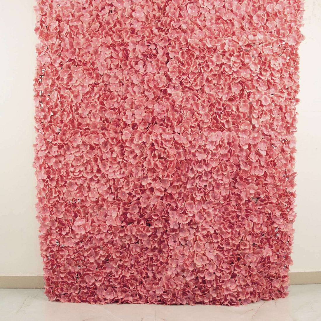 Pink floral wall backdrop for events and photography.