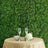 Elegant table setting with champagne glasses, flowers, and greenery backdrop.