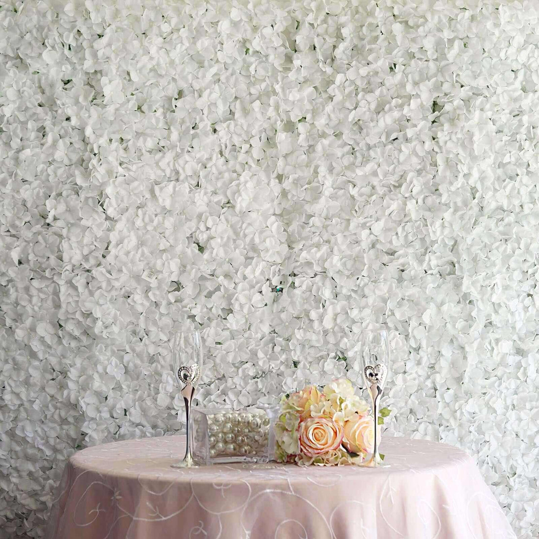 Elegant wedding table setup with floral decor and champagne glasses.