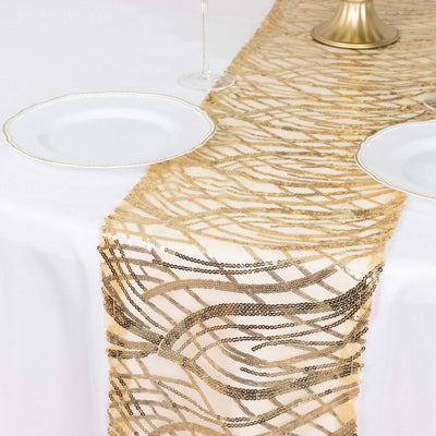 Gold sequin table runner on a white table with plates and glassware.