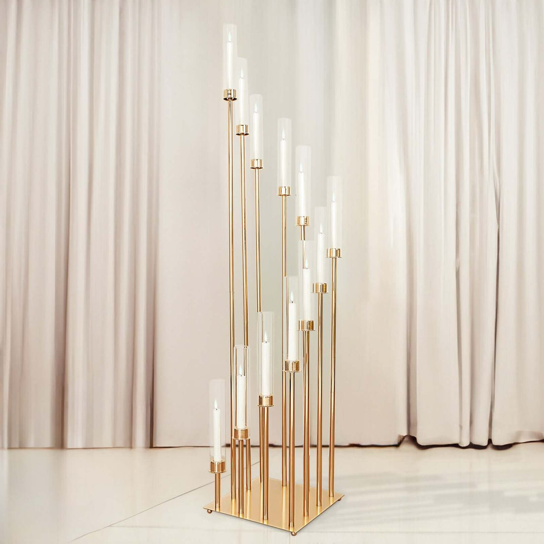 Elegant gold candle holder with multiple glass tubes against a soft backdrop.