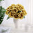 Yellow rose bouquet in white vase on a table