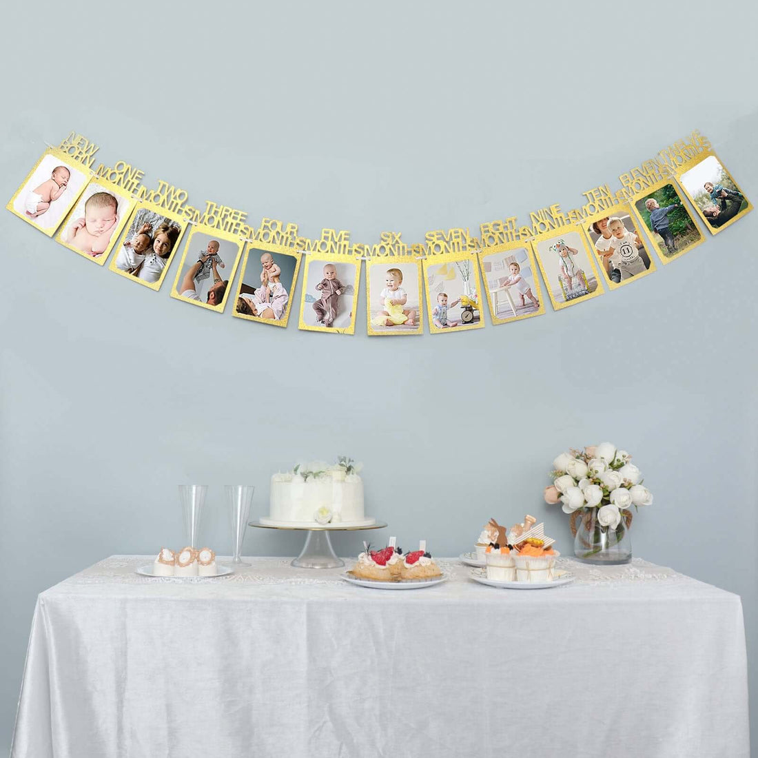 Gold milestone birthday banner with photos on a decorated table.