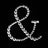 Rhinestone ampersand decoration on black background.