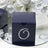 Navy gift box with decorative swirl design and rhinestones