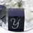 Navy gift box with rhinestone 'Y' design on a reflective surface.