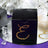 Black gift box adorned with amber gemstones on a reflective surface.