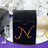 Black gift box with rhinestone 'N' design on reflective surface.