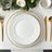 Elegant white plate with gold beaded trim on a stylish tablescape.