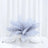 Silvery feather centerpiece in a clear vase on a table setting