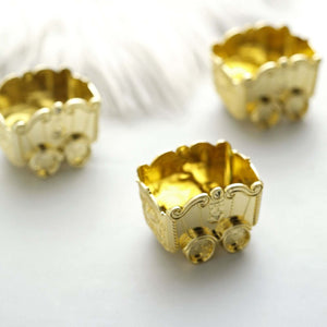 Golden decorative carts on a plain background