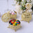 Gold decorative candy boxes with colorful sweets inside.