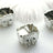 Silver baby carriage decorative piece on a light backdrop.