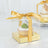 Clear dessert gift box with a golden ribbon and a cupcake inside.