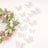Decorative white lace butterflies around a floral wreath