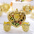 Gold heart-shaped carriage trinket holder with colorful beads inside.