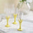 Elegant gold and clear shot glasses on a marble tray.