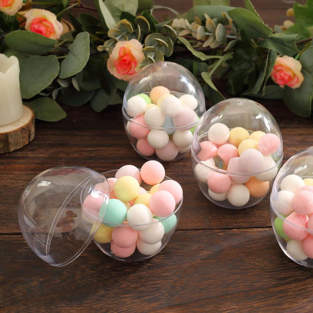 Colorful pastel balls in clear plastic containers on a wooden surface.