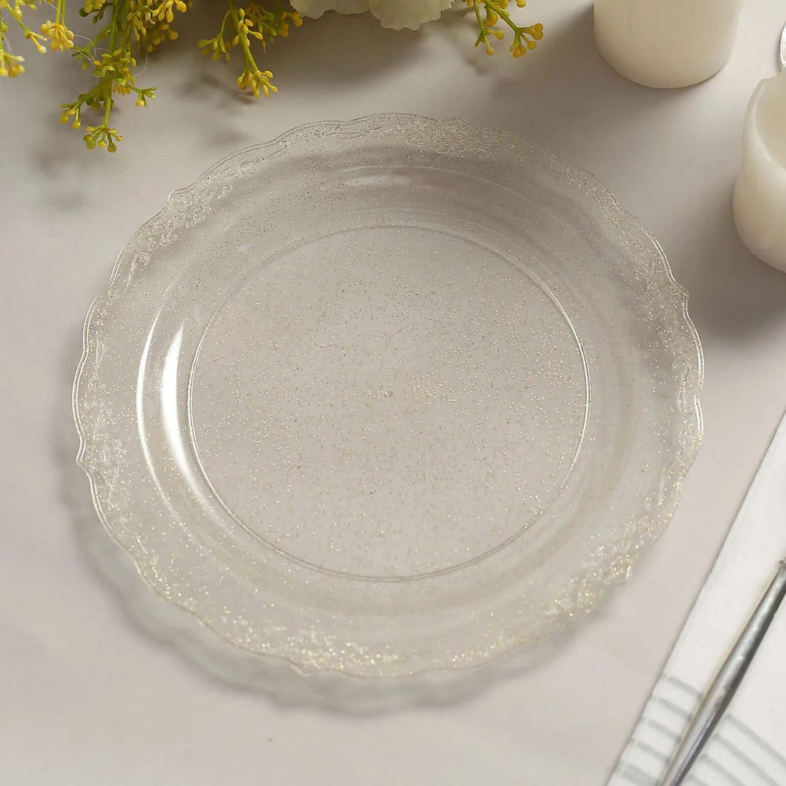 Clear decorative plate with a scalloped edge and glitter accents.