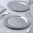 Polished silver serving plates on an elegant table setting.