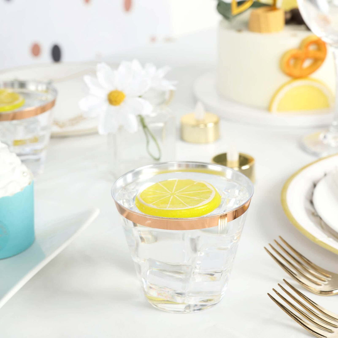 Clear glass with lemon slice garnish on a festive table setting.