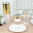 Clear plastic cups with gold rims on a wooden table.