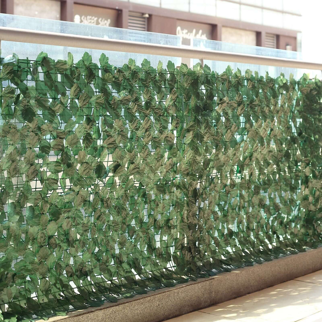 Artificial green leaves privacy screen for outdoor spaces.