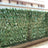 Artificial green leaves privacy screen for outdoor spaces.