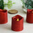 Red glitter LED candles in a decorative setting.