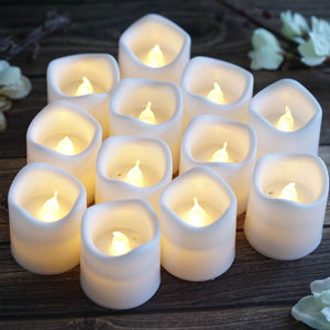 Set of 15 flameless LED candles in soft white holders, glowing softly.