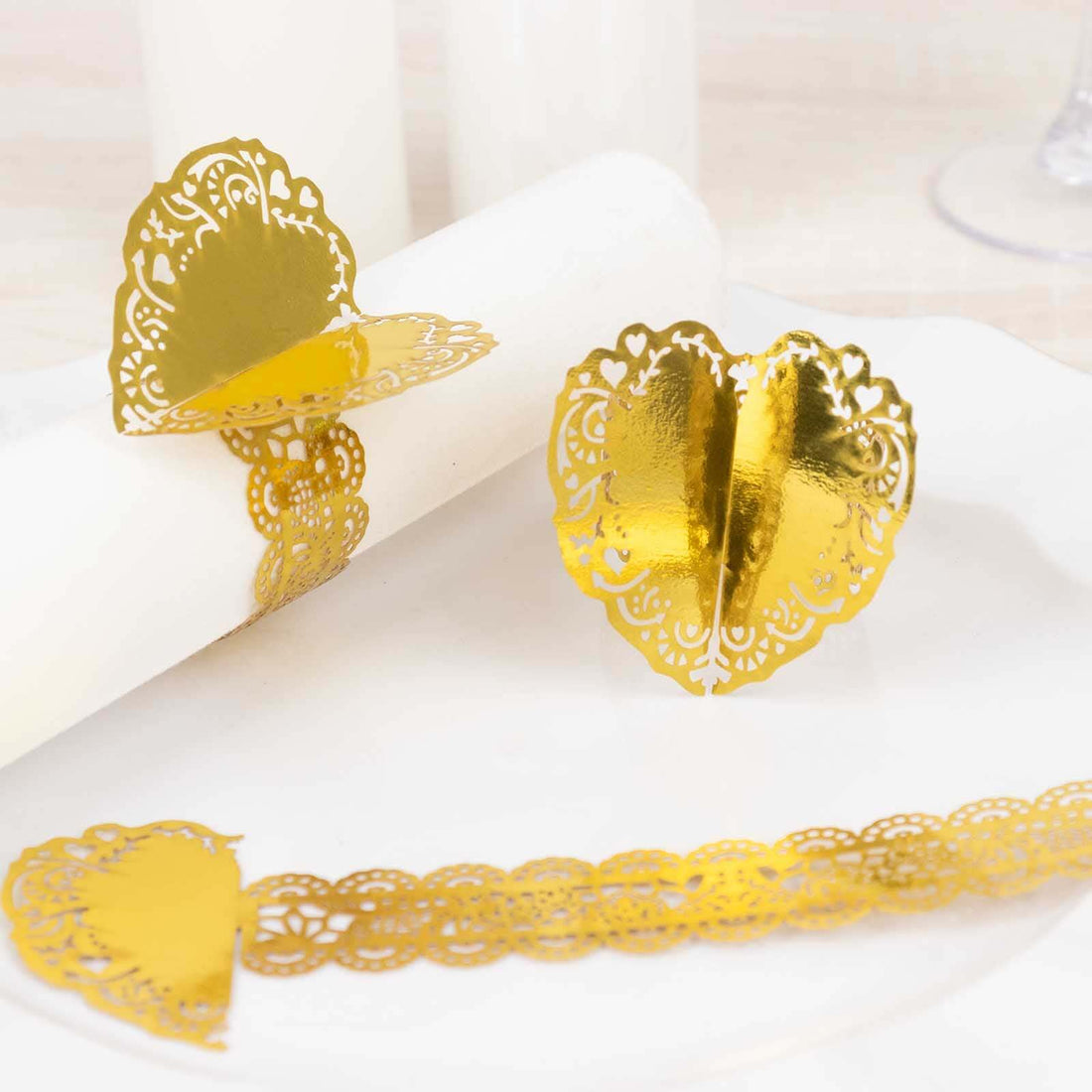 Gold heart-shaped napkin rings for elegant table settings.