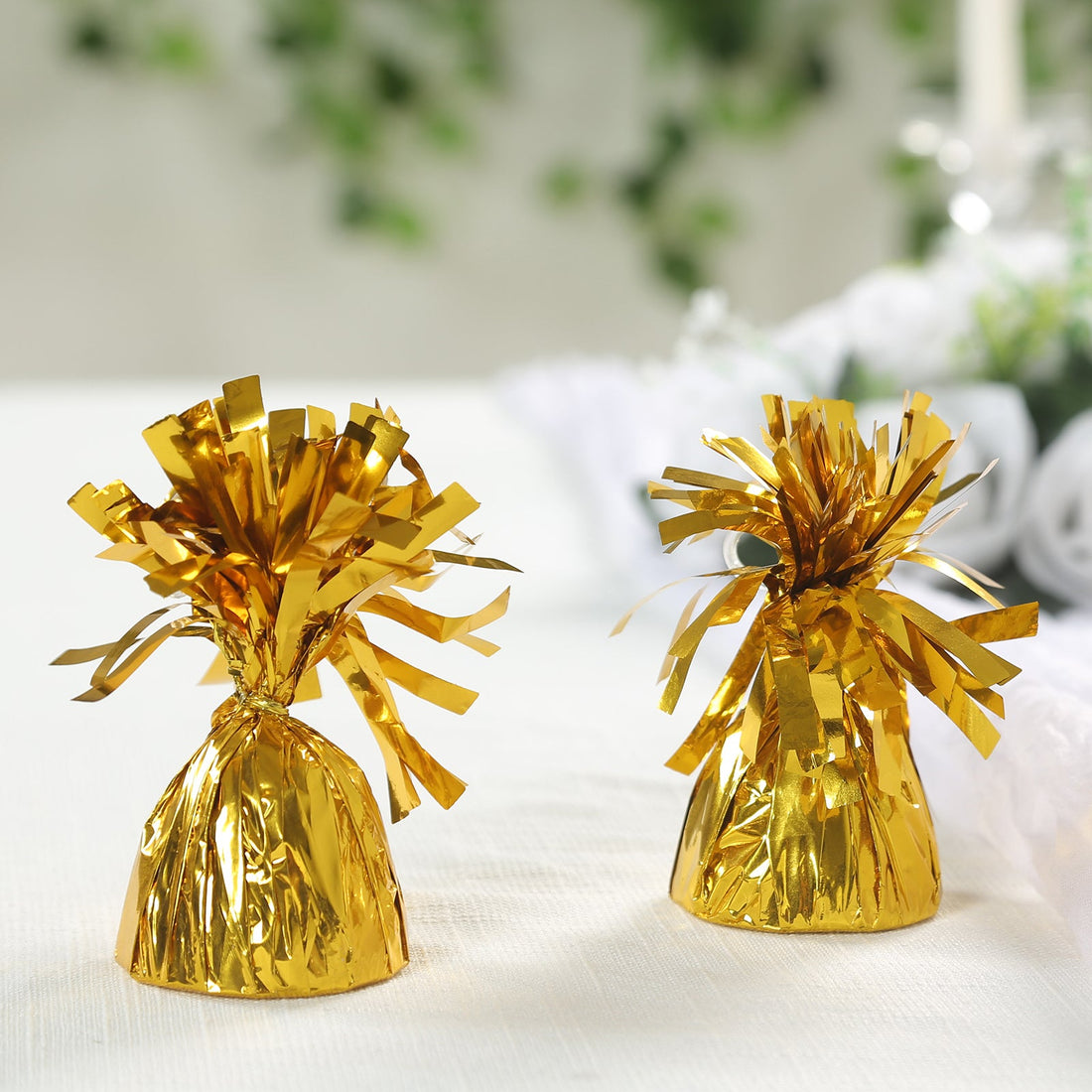 Golden decorative party favors with frilly tops.