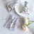 Silver gift bags filled with colorful candies on a white table.