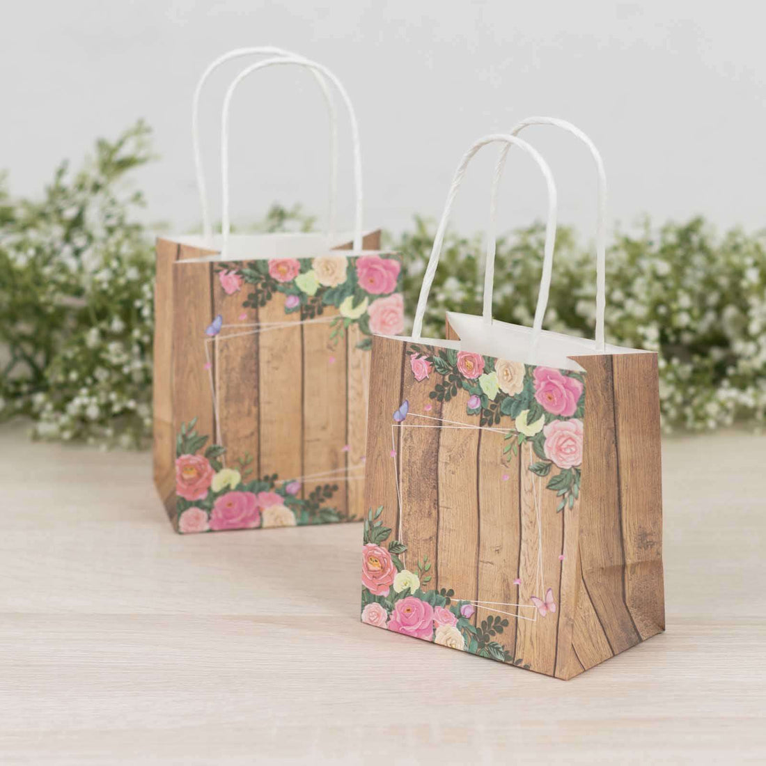 Floral design gift bags with wooden texture and handles.