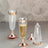 Iridescent champagne flutes with rose gold accents and matching lids.