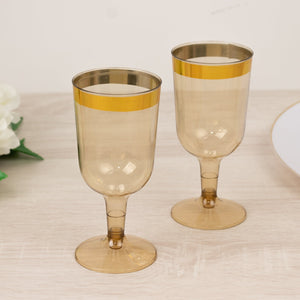 Two elegant amber champagne glasses with a gold stripe detail.