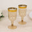 Two elegant amber champagne glasses with a gold stripe detail.