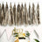 Birthday party decorations with tassels and cake centerpiece.