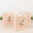 Decorative gift bags with floral design in soft pastel colors