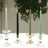 Elegant candle holders with lit candles in various colors on a table.