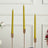 Twisted yellow candles in gold holders for elegant decor.