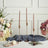 Elegant pink twisted candles in sleek holders with floral arrangements.