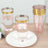 Set of stylish pink and gold rimmed drinking glasses on a plate.