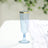 Blue champagne flute with gold rim on a soft background.