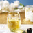 Elegant glass with golden rim filled with yellow beverage on a tabletop.